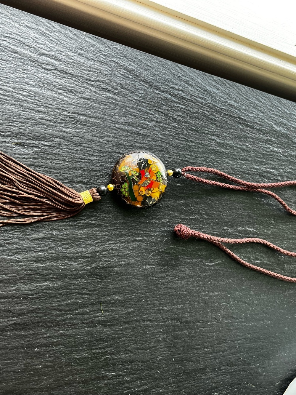 Round Cloissone pendant with gold bead details on 28” silk cord and tassel